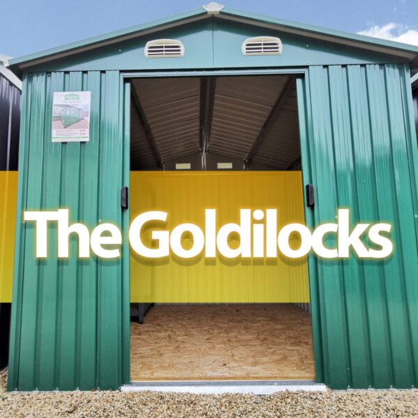 The Goldilocks Shed. It is a picture from a low angle of the front of the shed. The double doors are open and a photoshopped orange bar appears inside the open doors and the words 'THE GOLDILOCKS' are written on this in large font in a shade of off-white.