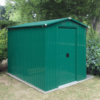 The 6ft x 9ft green, steel garden shed in a shaded garden