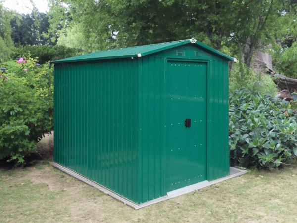 The 6ft x 9ft green, steel garden shed in a shaded garden