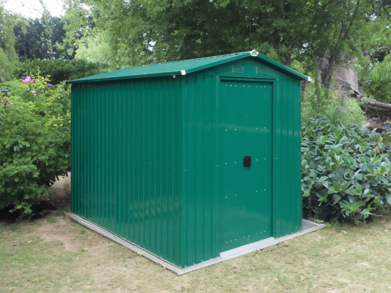 The 6ft x 9ft green, steel garden shed in a shaded garden