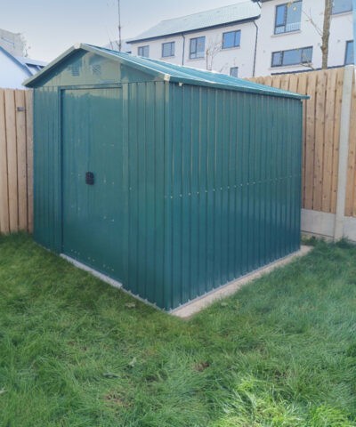 The green 6ft x 9ft steel shed in a garden