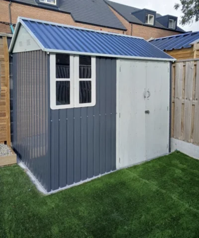 Steel Cottage shed 8ft x 6ft in a garden with artificial grass