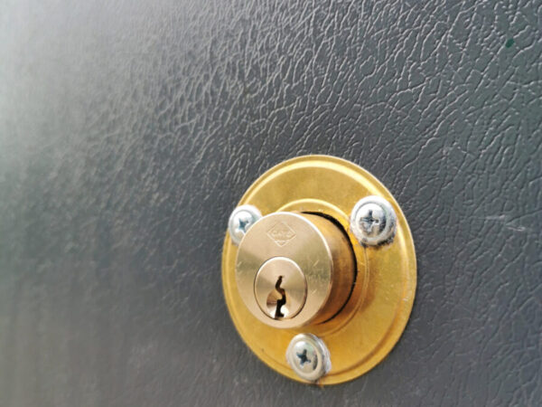 The new built in keylock on the PVC Cladded sheds from Sheds Direct Ireland in Dublin. The lock itself is circular and gold and it protrudes from the door by about one inch. There is a circular mount around it that is also gold and three screws attach this to the wall.