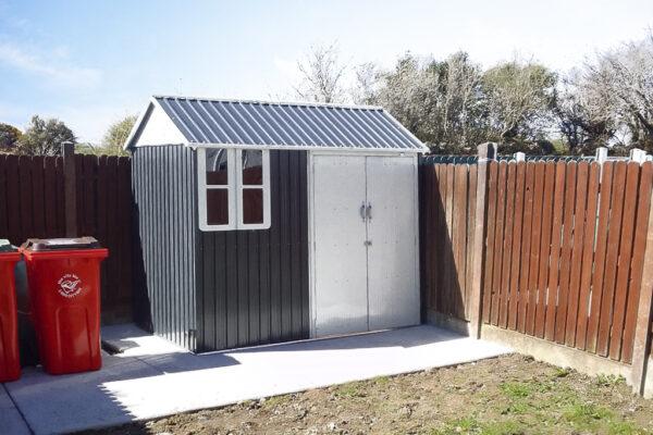 The 8ft x 6ft Steel Cottage shed in a customer's garden with two wheelie bins to the left of it