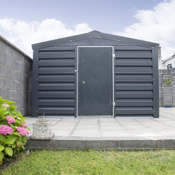 A heavy Duty, PVC Coated Shed in a Dublin garden. There is grass in the foregroiund and a pink flower to the left. The shed is sitting on