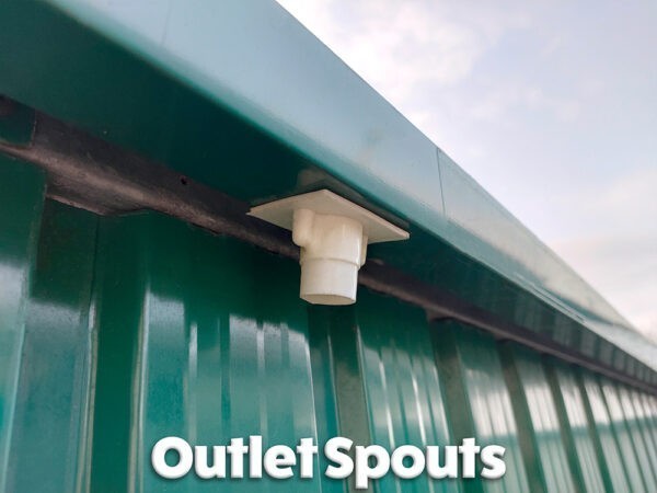 The outlet spouts on the green steel garden shed.