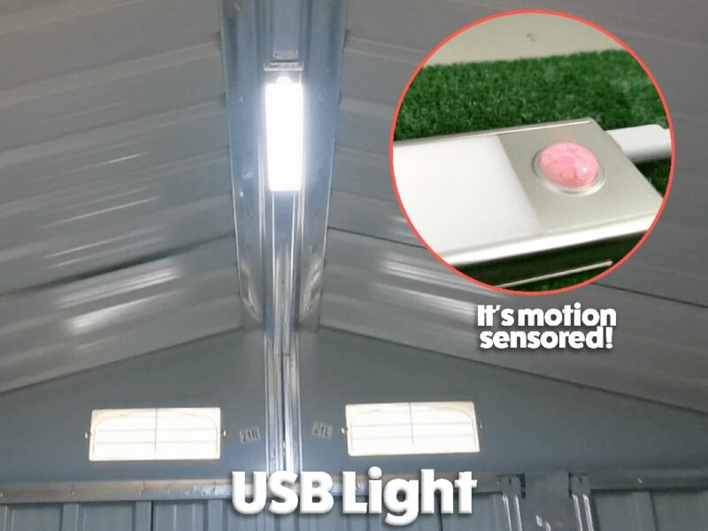 the usb light mounted to the roof of a steel hed. iT IS ILLUMINATING THE INSIDE OF THE SHED. TEXT TO THE SIDE READS 'IT'S MOTION SENSORED'