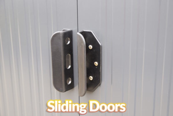 A close up view of the black handles of the steel pent shed. The doors behind are grey and matte but slightly reflective. It says 'sliding doors' in text just below them on the image