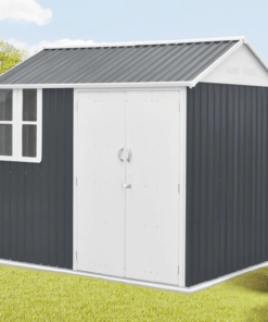 The 7ft x 6ft cottage shed in a garden against a dark-grey wall