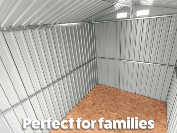 Inside the steel garden shed which is grey walled and which has a ply floor and text on top that reads 'perfect for families!'