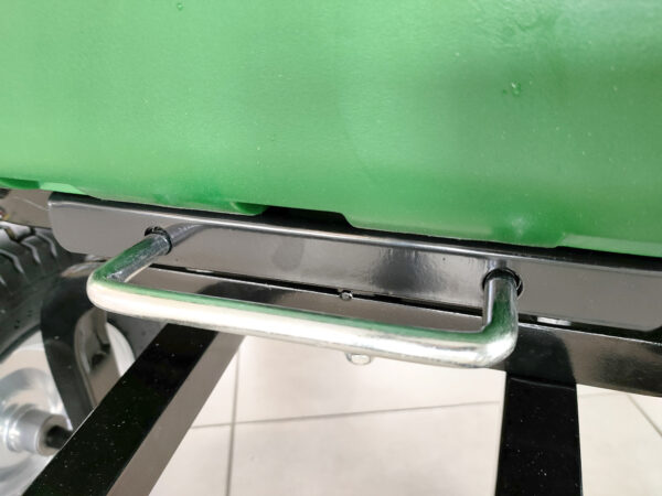 The pull-handle tab on the cart which when pulled, allows the cart to tip
