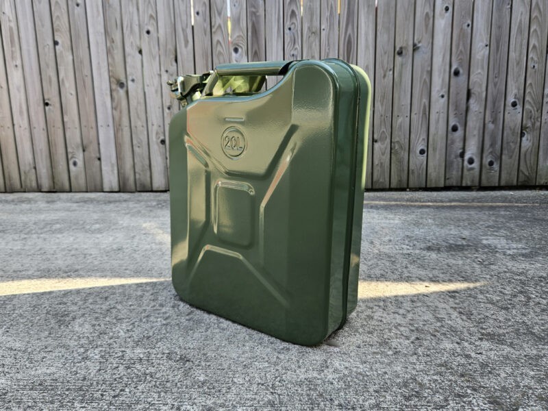 The 20L Jerry Can in green against a wooden panel wall