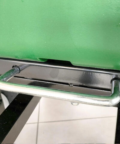 The pull bar to raise the bucket on the tip cart