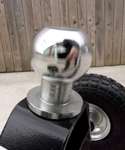 The 50mm, shiny silver ball-head attachment on the trailer dolly. It is a close up photo, with little else visible in the frame.