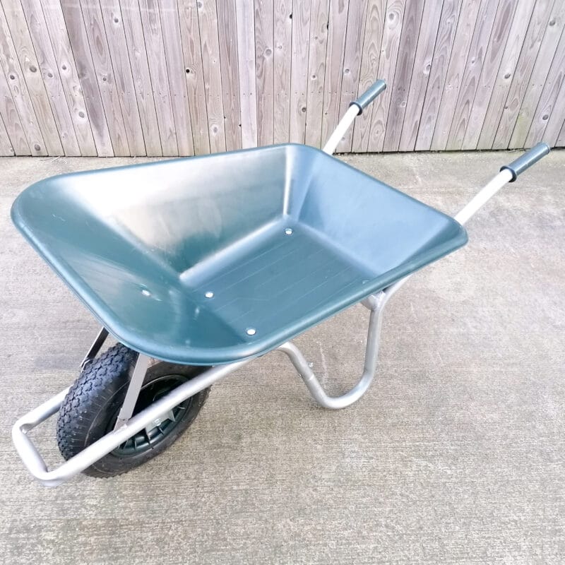 The 100L dark green wheelbarrow as seen from above. It has a silver frame and black, thick wheel