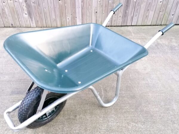The 100L dark green wheelbarrow as seen from above. It has a silver frame and black, thick wheel
