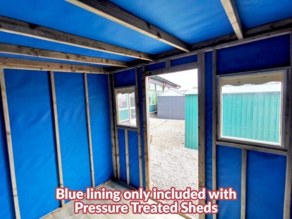 The inside of a wooden cabin. It is lined with blue felt and there are wooden joysts there for support.