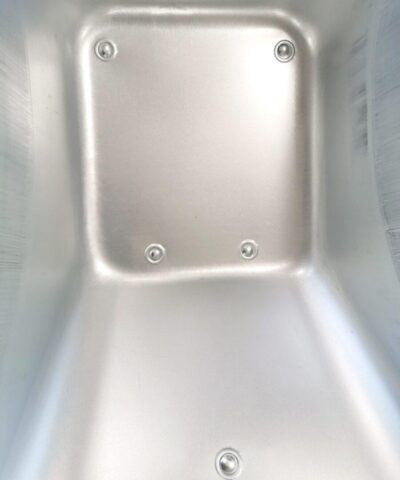 The internal detail of the barrow on the steel wheelbarrow. It's polished steel with 5 covered rivits visible.