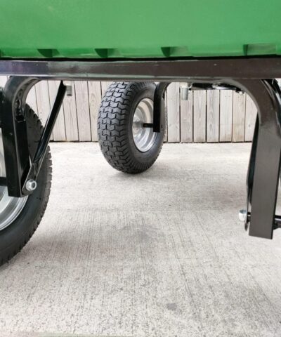 A view of the four, large wheels on the tipping cart as seen from below the cart. They have thick connections to the main chassis and they are pump tyres, as opposed to solid ones.
