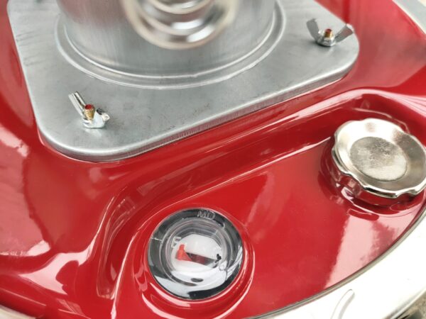 A close look at the fuel cauge and refulling port on the camping stove heater