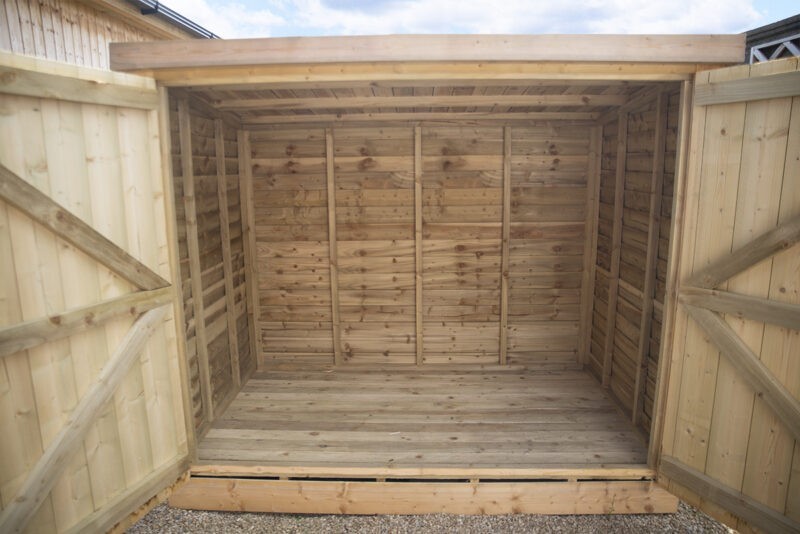 Both doors open on the wooden bike shed