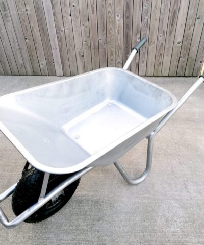 A steel wheelbarrow as seen from a high angle. The inside is bright and semi-shiny.