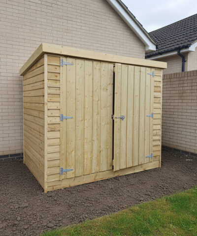 The wooden bike shed front and side with doors slightly open