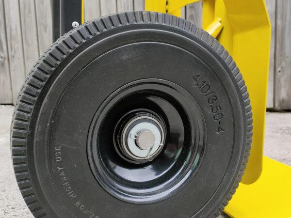 The large, solid, non-puncture wheels on the industrial hand truck