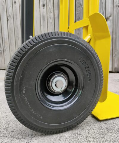The large, solid, non-puncture wheels on the industrial hand truck