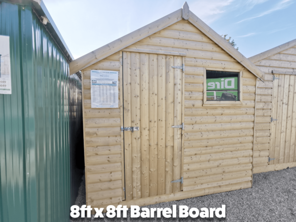 The outside of the 8ft x 8ft barrel board wooden shed. I has one window and an offset door