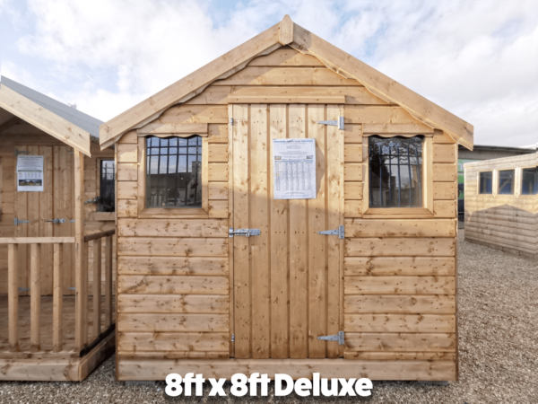 The 8ft x 8ft deluxe wood garden shed. It has two windows on the front and a door between them.
