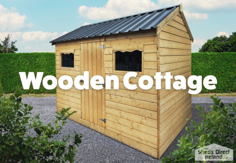 Wooden cottage shed. outside in gravel. light brown in colour.