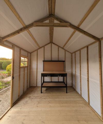 Interior view of a wooden cottage shed, looking towards the door