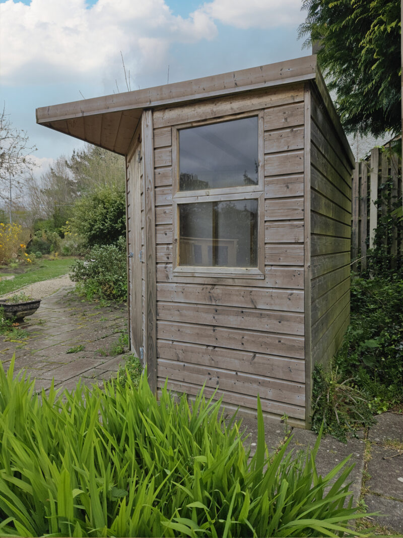 The side and back of the corner shed