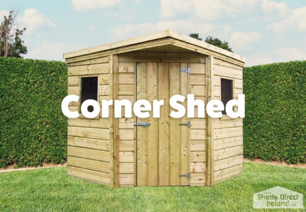 a corner shed, against two walls in an Irish back garden. There are flowers in the foreground and a chair to the side of the shed. The shed is unusual in shape, as one corner appears to have been cut off. The door is on this truncated corner, with 2 windows, one on either side of the door.