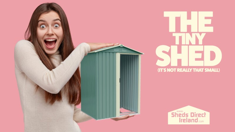 A woman holding the tiny shed in her arms. To the side it reads 'the tiny shed (it's not really that small!)'