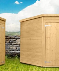 Two corner sheds set up beside each other. One is in a profile view, the other is face on. The wood is a golden, pale colour. Each shed has one window. They are set against an old irish stone wall, witha . bright blue sky behind the,