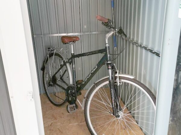 A man's mountain bike in the 4ft x 6ft steel shed standing upright.