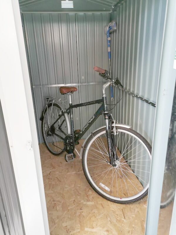 A man's mountain bike in the 4ft x 6ft steel shed standing upright.