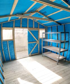 A vertical image taken inside the taller wooden shed. The sides are warped, as a fish-eye lens has been used. The walls inside the shed are blue, the floor is a pale wood colour and light is pouring in the door. Outside the door, only a grey wall is visible