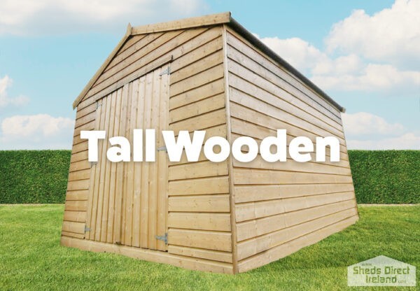 tall wooden shed on grass with blue sky and green hedges.