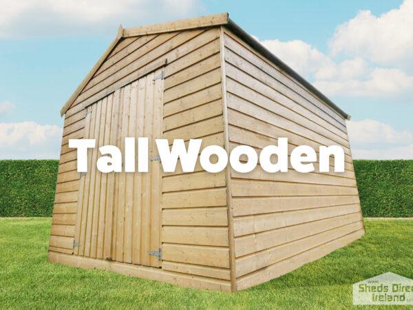 tall wooden shed on grass with blue sky and green hedges.