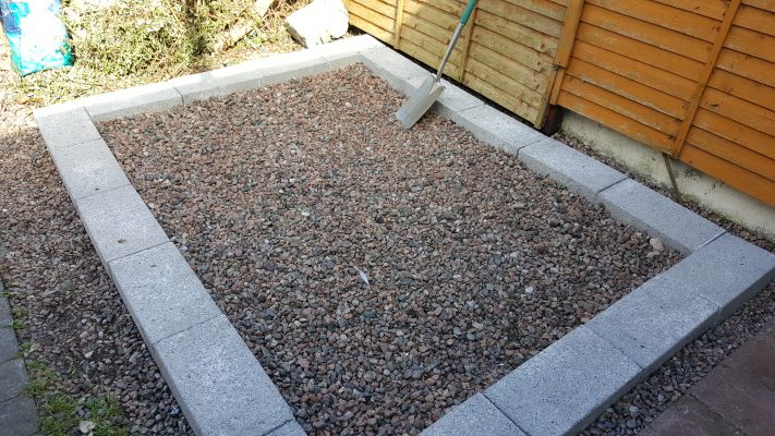 An unacceptable base for a steel shed. It's concrete blocks around the edge and an internal mix of stone and gravel. 