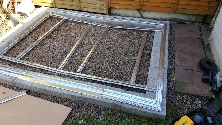 An unacceptable base for a steel shed. It's concrete blocks around the edge and an internal mix of stone and gravel. 