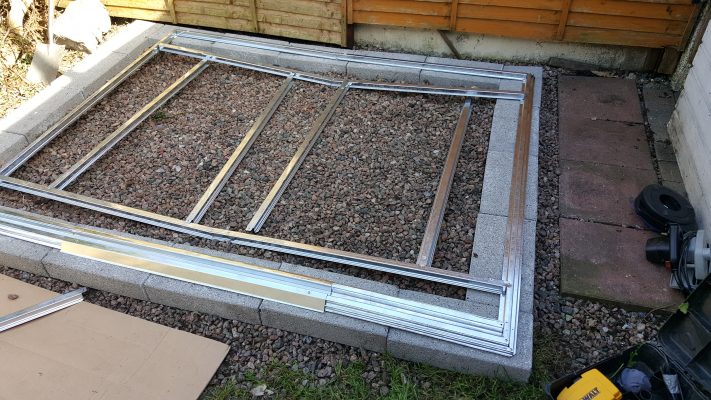 An unacceptable base for a steel shed. It's concrete blocks around the edge and an internal mix of stone and gravel. 