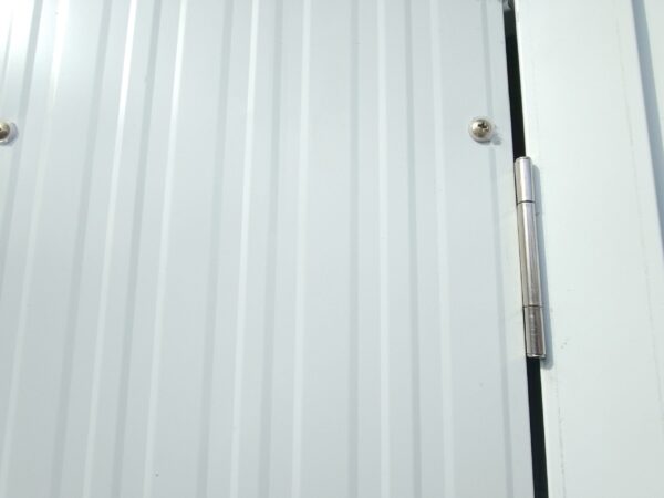 A close look at the hinged doors of the shed