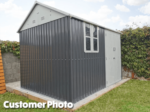 A customer's photo of the cottage shed. It's on a concrete base in the corner of a garden