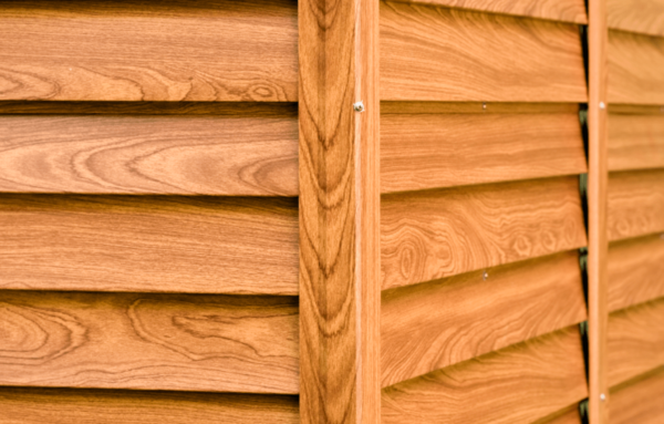 A close up of the panels on a wood grain shed. There's are 6 panels visible which are inset into two sturdier looking panels.