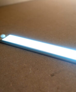 A long, silver LED Light on steel shelving unit