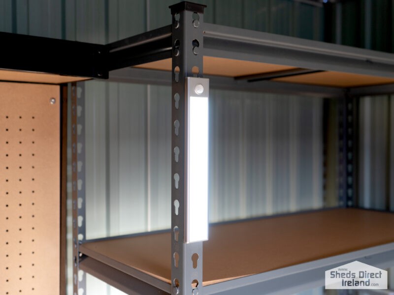 A long, silver LED Light on steel shelving unit